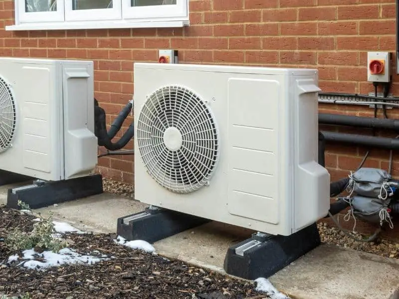 Air source heat pumps outside a house