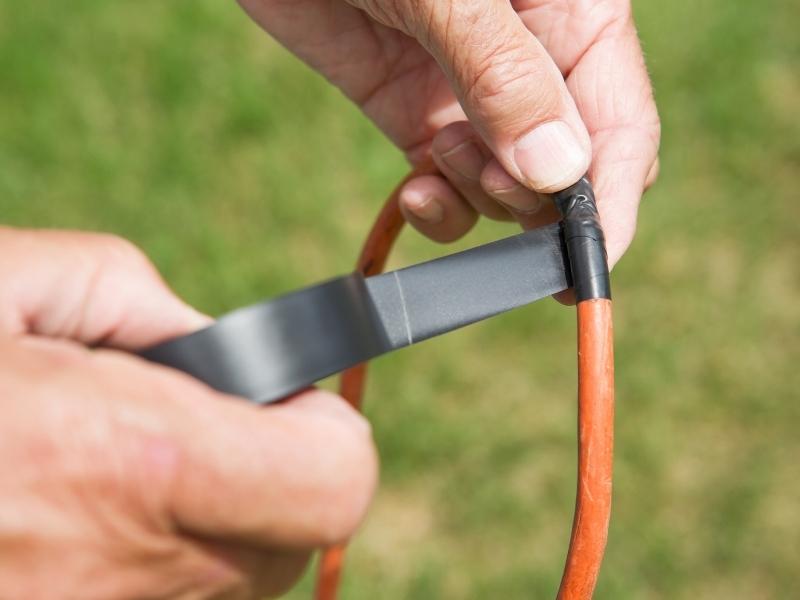 Electric tape being put on wire