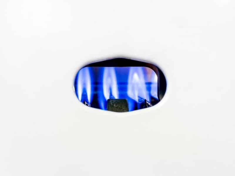 Gas pilot light behind a white cover