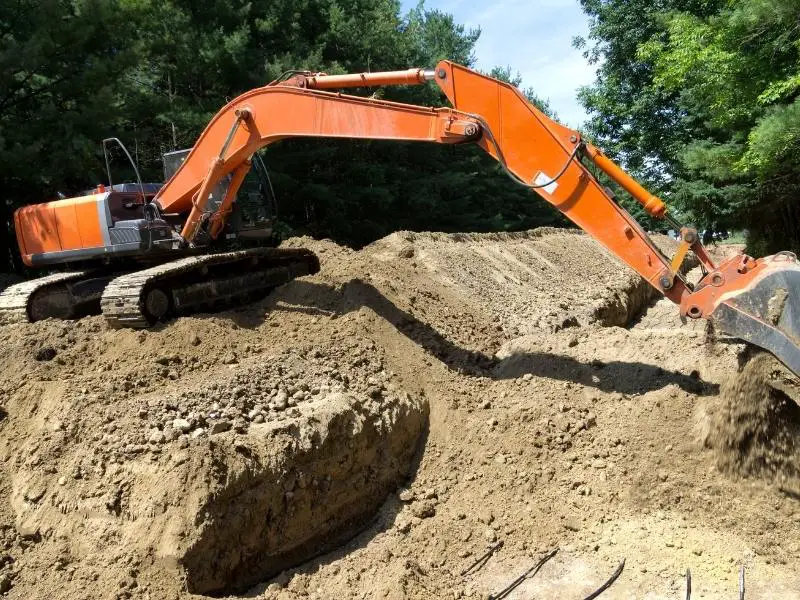 Geothermal heat pump pipe under earth digger moving earth