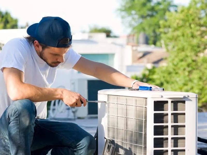 Man opening a heat pump