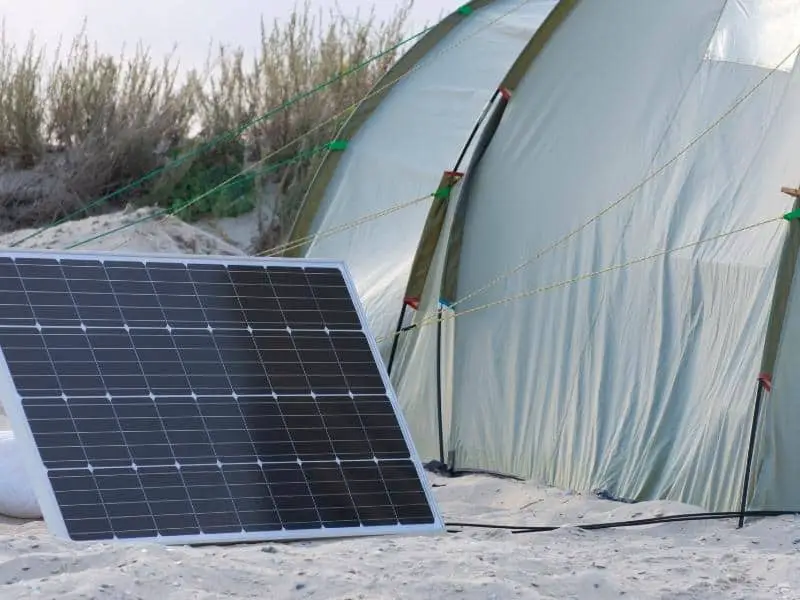 Solar panel charging by a tent