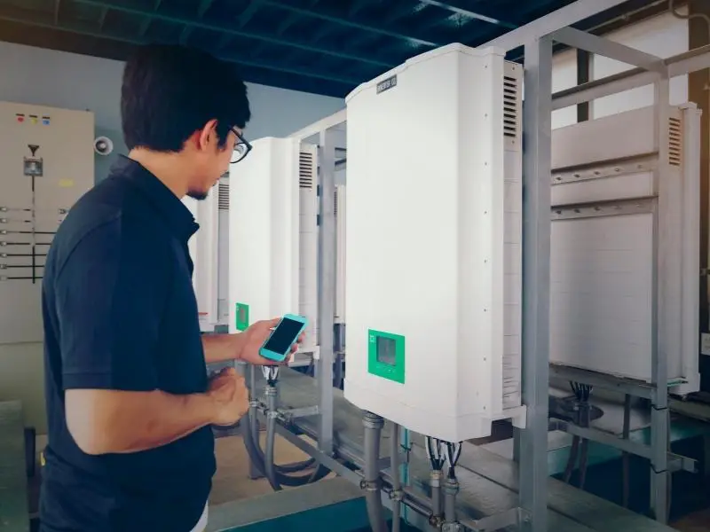 Solar panel inverters man inspecting