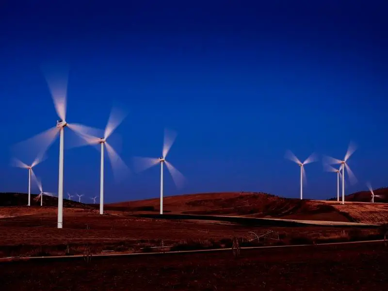 Wind turbines spinning fast in the night