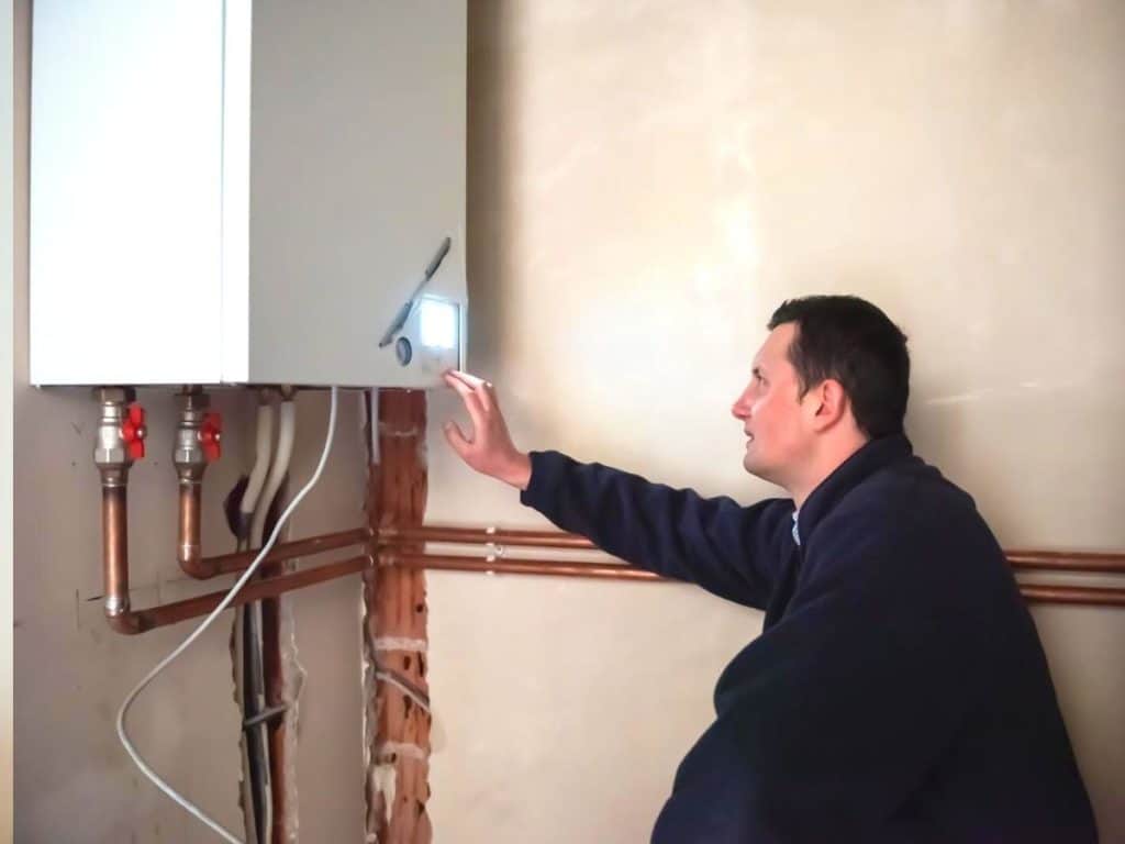 Engineer Installing A Furnace Water Heater