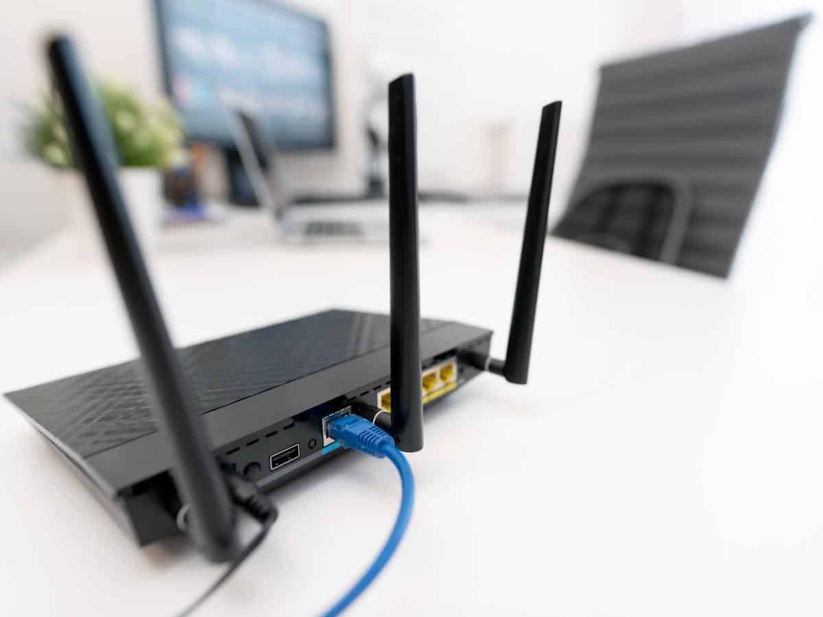 Router with power cable on a computer desk