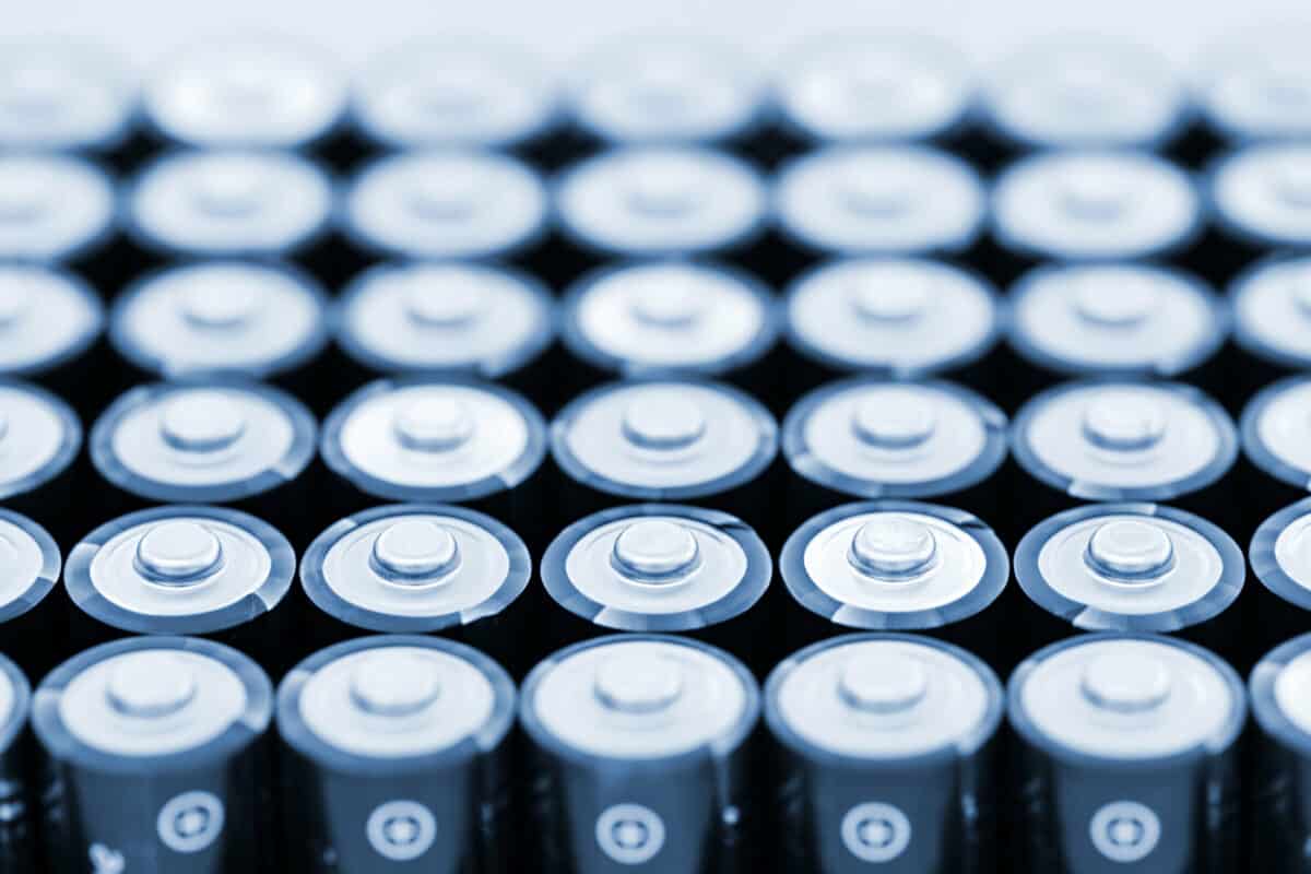 Tops of many AA batteries in closeup.