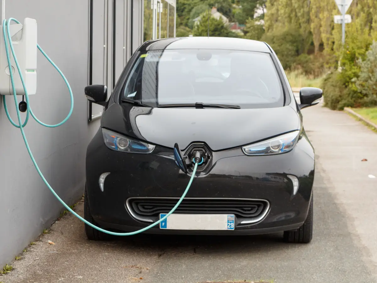 Small black electric car charging